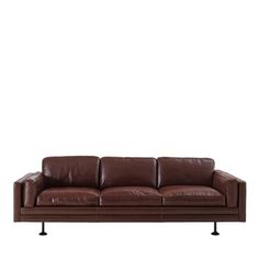 a brown leather couch sitting on top of a white wall