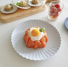 an assortment of appetizers are displayed on paper plates