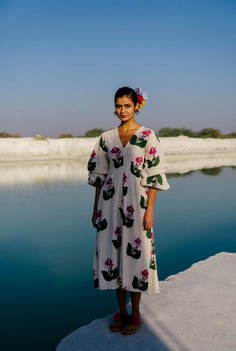 That white dress you need this summer- the JODI version is crafted in handwoven cotton and hand block printed in bold blooms. This fit-and-flare dress has dramatic doubly puffed sleeves and a flattering neckline. A special mention for this handcrafted fabric, it feels lovely on the skin and has a malleable texture. We believe you have a right to know how this product was made. 3.5 metres of handloom fabric sourced from West Bengal has been used for this piece. Hand printed by our artisans in Jaipur, manufactured in our workshop at Pune India. This product is hand-printed in Jaipur, India using traditional techniques. Subtle variations in patterns are natural to this process. We believe this makes each creation unique and charming.If you wish to have the length of the garment altered, pleas Block Print Dress Western, Block Print Kurti Designs, Printed Kurti Designs, Mens Outerwear Fashion, Block Print Dress, Resort Chic, Handloom Fabric, Printed Kurti, Hand Woven Textiles