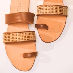 A three-strap sandal with a toe loop, now available in versatile Tan. Featuring handwoven rattan in a square weave pattern and crafted with genuine leather, the Rina Slides blend style, comfort, and functionality. This piece highlights thin strands of rattan, intricately handwoven into a classic square weave pattern. Traditionally used for baskets and furniture, this naturally sustainable material is lightweight, durable, and flexible—perfect for both indoor and outdoor use. Elevate your wardrobe staples with these two new hues, designed to complement every look effortlessly. Details • Handwoven rattan upper • Genuine soft lambskin leather underlay and trim • Genuine leather insole • Double-soled heel • Rubber sole Care: Use of leather protector is recommended before wear. Given its rattan Piece Highlights, Weave Pattern, Womens Sandals Flat, Lambskin Leather, Strap Sandals, Wardrobe Staples, Rubber Sole, Baskets, Hand Weaving