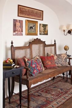 a living room filled with furniture and pictures on the wall