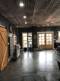 the inside of a garage with several tables and chairs