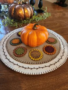 a small pumpkin sitting on top of a wooden table