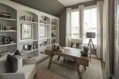 a living room filled with furniture and bookshelves next to a window covered in blinds