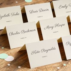 place cards with names on them sitting on a table