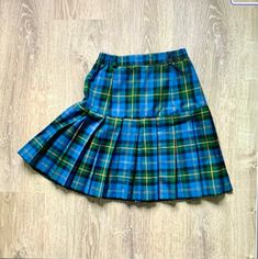 Vintage 1980s Plaid Pleated Mini Skirt Blue Green plaid drop waist pleated short above the knee skirt High waistband with elastic on sides Polyester or Polyester blend 1980s era In fabulous vintage condition I realize now that the zipper should be probably in back not in front as photos show Tag: AH CHI FASHION Size: Measures Size 4 Woman's USA--check measurements: Will fit: Waist: 25 inches and stretches to 26 inches Hip: 36 inches to 37 inches--measured 8 inches below the waist Length: 19 1/2 inches--short above the knee Above The Knee Skirt, Mini Skirt Vintage, Preppy Skirt, Mini Skirt Blue, Plaid Pleated Mini Skirt, Knee Skirt, Knee Skirts, Skirt Vintage, Pleated Shorts