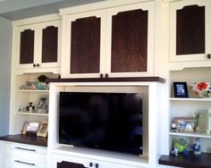 an entertainment center with built in cabinets and a flat screen tv mounted on the wall