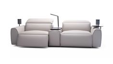 a white couch with two recliners and a lamp on the end table in front of it