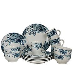 a blue and white dinner set with flowers on it