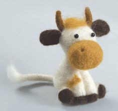 a small stuffed giraffe sitting on top of a white table