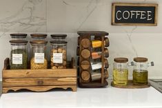 an assortment of spices and condiments on a kitchen counter with a sign that says coffee