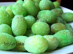 green powdered sugar balls on a white plate