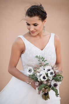 a woman in a wedding dress holding a bouquet