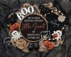 a halloween wreath made out of clothes and other items on top of a black blanket