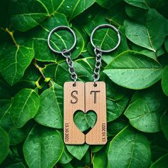 two wooden keychains with the words sit on them