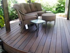 a couch and chair on a wooden deck