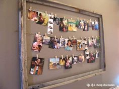 a bulletin board with pictures pinned to clothes pegs on it, hanging from the wall