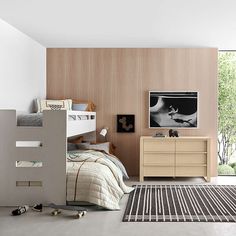 a bedroom with two bunk beds and a rug in front of the bed on the floor