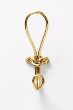 an image of a gold hook on a white background