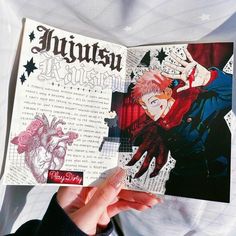 a person holding up an open book with illustrations on it