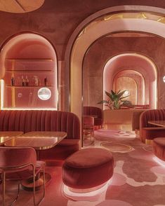 the interior of a fancy restaurant with pink and gold decor on the walls, flooring and tables