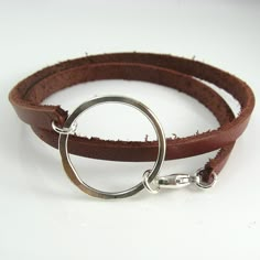 A chunky leather double wrap bracelet with a handcrafted circle centerpiece is ruggedly dainty. The leather is 5mm wide and 2mm thick and the sterling silver centerpiece measures about 1-1/4 inches (3 cm) wide. All held together with a sterling silver lobster clasp. Leather is available in Black, Brown, White and Dark Red-Brown.Please measure your wrist to find the best size for you. Add length based on whether you prefer a looser or tighter fit and select the size that best corresponds to your Leather Belt Crafts, Leather Bracelet Tutorial, Leather Cord Jewelry, Double Bracelet, Diy Leather Bracelet, Hardware Jewelry, Banner Elk, Leather Jewellery, Brown Leather Bracelet