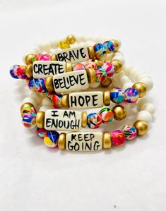 Affirmation bracelets featuring a hand-lettered affirmation focal bead and abstract print beads Stretchy to fit most wrists. Bead size - 8mm Focal bead - 18mm 7.75" centerline Beaded Bracelet Thick, Inspirational Word Bracelets, Diy Stacking Bracelets, Jewelry Making With Beads, Letter Bracelets Ideas, Friendship Bracelets Designs With Beads, Positive Affirmation Bracelets, Letter Bracelet Ideas, How To Make Bead Bracelets