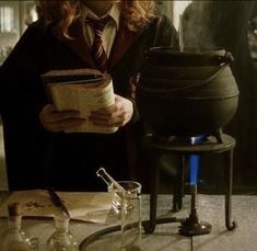 a harry potter holding an open book