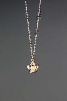 "A sweet and delicate 18k gold vermeil Plumeria flower charm simply dangles from a 14k gold filled chain. Choose from a 1mm 14k gold filled chain with a gold spring ring clasp, or a 1.5mm 14k gold filled chain with a gold lobster clasp. Each chain measures 16\" with an extension to 18\".  Please send a message if a different length chain is desired. This small and lightweight go-with-everything necklace completes any outfit for daytime or evening.   Gold flower charm: 12x11mm Total length of cha Plumeria Flower Necklace, Everyday Gold Jewelry In Flower Shape, Delicate Flower-shaped Everyday Jewelry, Delicate Flower Shaped Everyday Jewelry, Delicate Yellow Gold Jewelry With Flower Charm, Dainty Yellow Gold Flower Jewelry, Delicate Everyday Flower Shaped Jewelry, Flower Gold Necklace, Gold Flower Shaped Necklace For Everyday