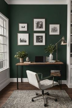 a home office with green walls and pictures on the wall above it, along with a white chair