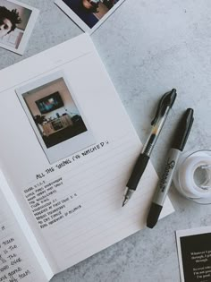 an open book with writing on it next to a cup of coffee and some pens