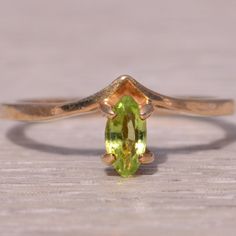 This Stunning Piece, Known As The Verdant Glow, Features A Captivating Marquise-Cut Peridot At Its Center, Exuding A Vibrant Green Hue. The Peridot Is Elegantly Set In A Yellow Gold Band, Creating A Sleek And Modern Design That Enhances The Gem's Natural Beauty. This Exquisite Ring Is Currently A Finger Size 6 Yet Can Be Adjusted To Any Finger Size For An Additional Charge Upon Request, Ensuring A Perfect Fit. Yellow Gold Color, Peridot Ring, Vibrant Green, Marquise Cut, Gold Band, Womens Jewelry Rings, Gold Bands, Green Yellow, Natural Beauty