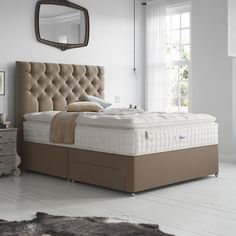 a bed sitting in a bedroom next to a dresser with drawers on top of it