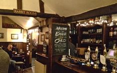 the interior of a bar with many bottles on it