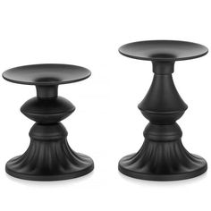 two black candlesticks sitting next to each other