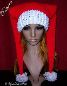 a mannequin head wearing a red and white knitted hat