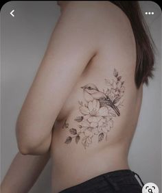 a woman's chest with flowers and birds on it