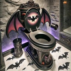 a bathroom with a toilet decorated like a bat