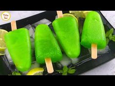 three popsicles with limes and lemon slices on them