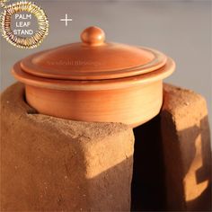 a clay pot sitting on top of a brick wall next to a cement block with the words, i am leaf stand above it