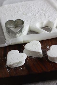 some heart shaped marshmallows on a cutting board