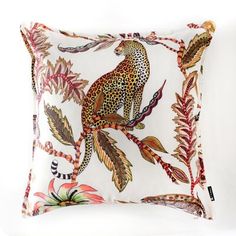 a pillow with a leopard sitting on top of a leafy branch in front of a white background