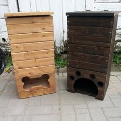 two wooden boxes sitting next to each other on the ground in front of a building