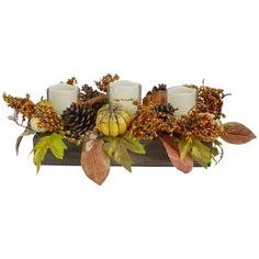 three candles are sitting on a table with autumn leaves and pineconis around them