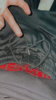 a person's hand on the back of a jacket with an iron cross embroidered on it