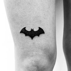 a small bat tattoo on the leg