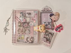 an assortment of items are displayed on a white surface with a bear keychain