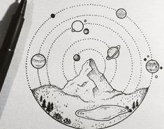 an ink drawing of mountains and planets in the sky with a pen on top of it