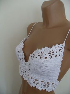 a mannequin wearing a white crochet top