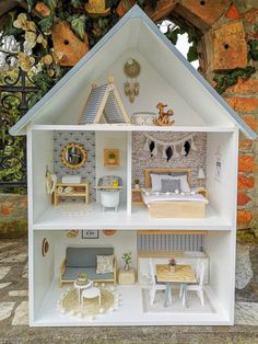 a doll house with furniture and accessories on display